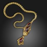 A large Victorian garnet snake necklace, the stylised serpent set with graduated garnet cabochons to