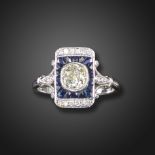 A sapphire and diamond rectangular cluster ring, the old cushion-shaped diamond is set within