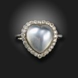 A moonstone and diamond heart ring, the cabochon moonstone set within a surround of old cushion-