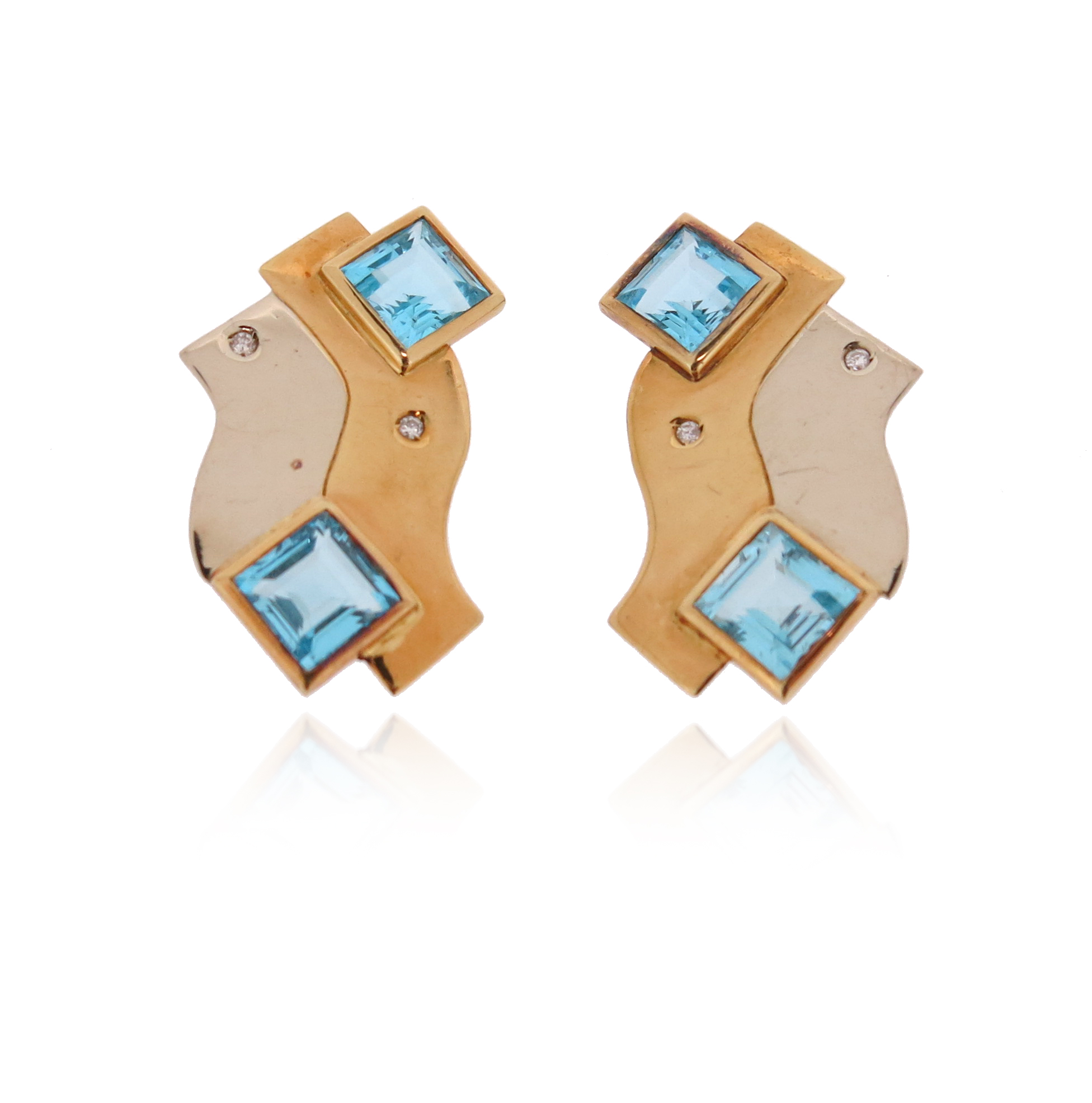 A pair of abstract topaz and diamond earrings by Manfredi, set with two square-shaped blue topaz and