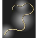 A gold 'Snake Necklace' by Elsa Peretti for Tiffany & Co., with a serpent's head clasp and graduated