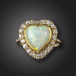 A heart-shaped opal and diamond cluster ring, the solid white opal heart-shaped cabochon is set