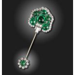 An emerald and diamond-set jabot pin, of stylised palmette form, set with six cabochon emeralds