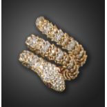 A gem-set gold snake ring, pave-set with round brilliant-cut diamonds to the head, tail and