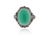 An Arts & Crafts chrysoprase silver ring, the oval-shaped chrysoprase set within an openwork foliate