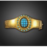 A Victorian turquoise and diamond bangle, the central raised oval dome pave-set with turquoise