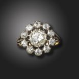 A late 19th century diamond cluster ring, set with graduated old cushion-shaped diamonds totalling