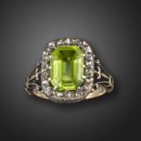 A Victorian peridot and diamond cluster ring, set with an emerald-cut peridot within a border of