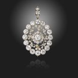 An Edwardian diamond-set brooch pendant, centred with a cluster of old circular-cut diamonds, within