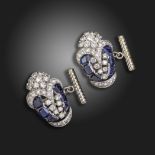 A pair of sapphire and diamond-set stylised pansy cufflinks, the graduated emerald-cut sapphires are