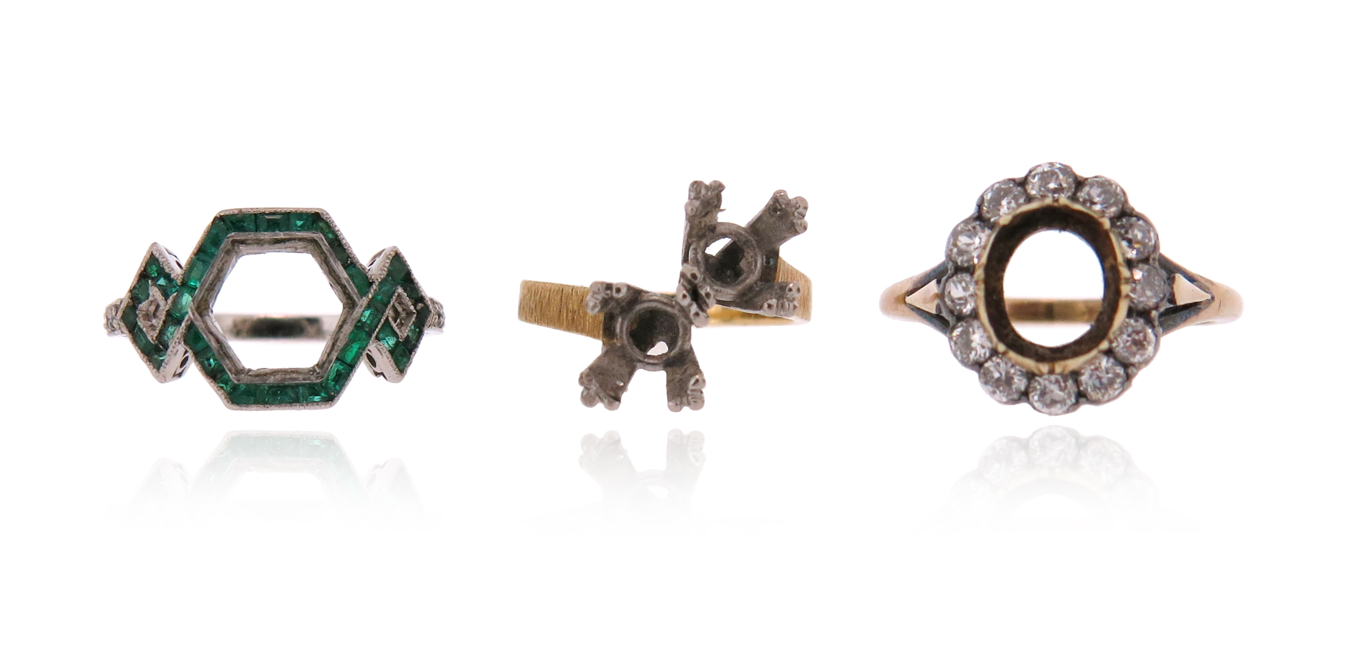 Three ring mounts, including a cluster setting with an oval surround of old circular-cut diamonds in