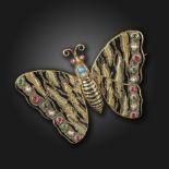 An Aesthetic Movement gem-set gold butterfly brooch, set with vari-coloured paste cabochons and seed