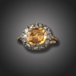 A George III topaz and diamond cluster ring, set with a cushion-shaped orange topaz in closed-back
