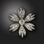 A George III diamond flowerhead brooch, set with a central old cushion-shaped diamond and six