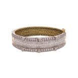 A diamond-set gold bangle, set with princess-cut and round brilliant-cut diamonds in platinum and