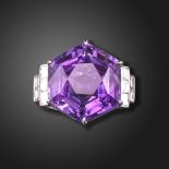 An amethyst and diamond ring, the hexagonal-shaped amethyst set with baguette-shaped shoulder