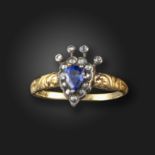 A sapphire and diamond cluster ring, centred with a pear-shaped sapphire within a surround of rose-