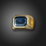 A sapphire and diamond-set gold ring, centred with a rectangular-shaped sapphire, with circular-