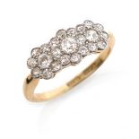 An Edwardian diamond triple cluster ring, millegrain-set with graduated old circular-cut diamonds in