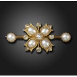 A Victorian pearl and diamond bar brooch, the flowerhead centre section set with untested half