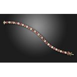 A ruby and diamond line bracelet, set with circular-cut diamonds and rubies in gold, diamonds