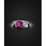 A ruby and diamond three-stone ring, the cushion-shaped ruby weighs 3.57cts, set with fancy-cut