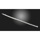 A slightly graduated diamond line bracelet, c.1925, the square-shaped diamonds channel-set in