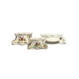 Two Derby figure stands c.1760-65, painted with panels of exotic birds alternating with moths and