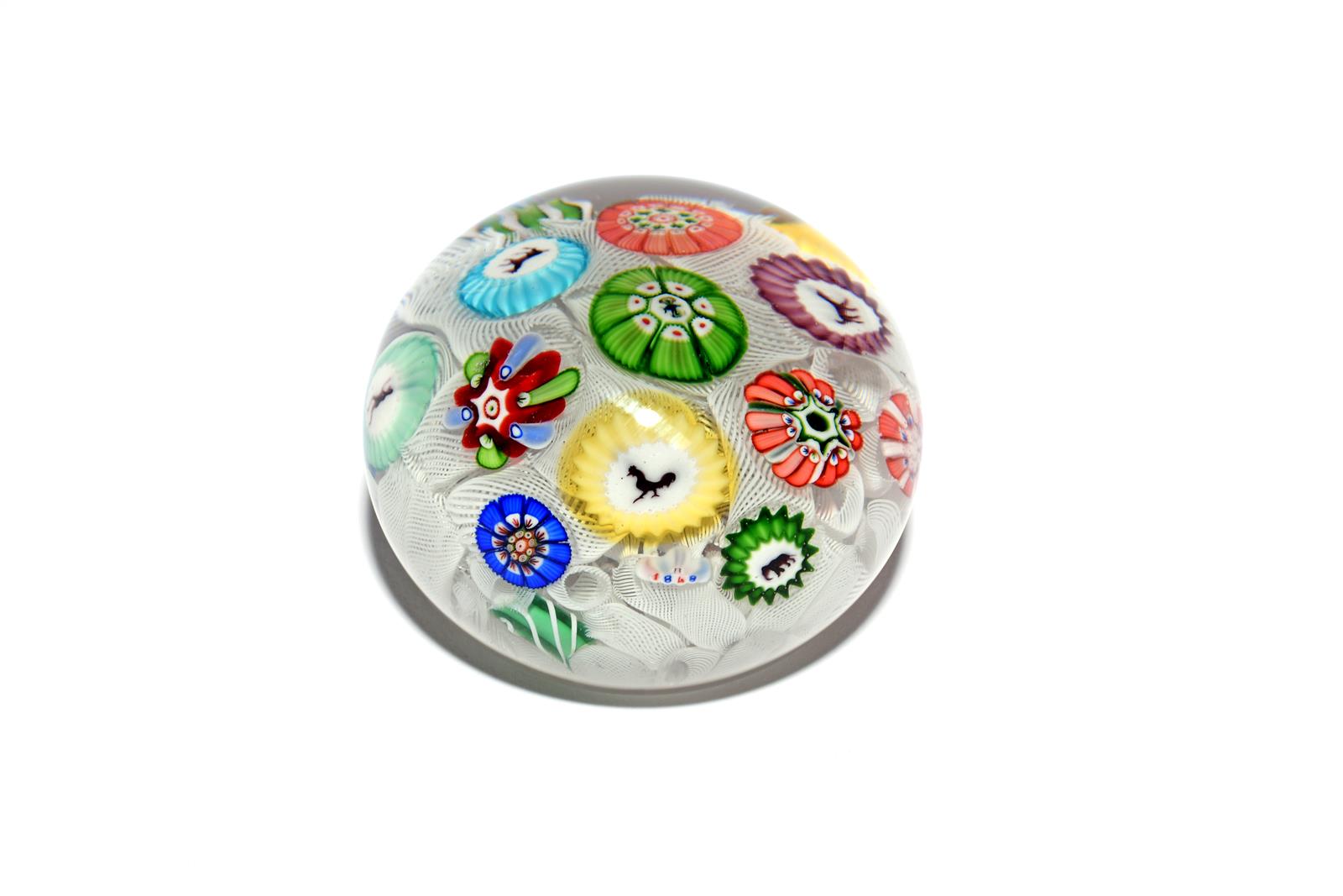 A Baccarat spaced millefiori paperweight dated 1848, set with thirteen individual canes including