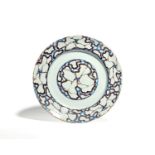 An unusual delftware charger c.1750-60, probably London, decorated to the well and rim with a