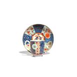 A Worcester coffee cup and saucer c.1765-70, decorated in a Japan pattern with Imari prunus to the