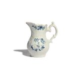 A rare Worcester blue and white cream jug c.1755-56, of strap-moulded form, the scrollwork panels