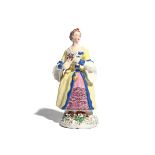 A rare Bow figure of a lady c.1758-60, copying a Meissen model by Peter Reinicke, wearing a