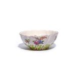 A large Chelsea bowl c.1760, the spiral lobed form moulded and coloured to the base with a band of