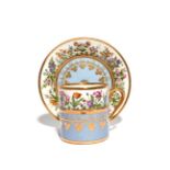 A Sèvres coffee can and saucer c.1816, painted with the garden (le jardin) pattern of flowering