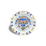 A large Delft charger c.1740, painted in red, yellow, blue and green with two birds flanking a large
