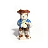 A Skew Face toby jug c.1800, modelled in typical fashion with a foaming jug of ale on one