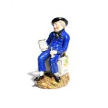 An American Sailor Toby jug c.1820, wearing a blue uniform with yellow buttons and seated on a sea