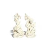 A pair of Derby biscuit porcelain figures of putti c.1780, each seated on rockwork beneath an oak