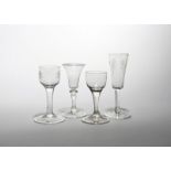 Four wine and ale glasses c.1740-50, the ale with a slender bowl engraved with hops and barley,
