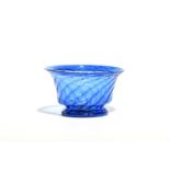 A small blue glass bowl c.1800, spiral moulded with a folded everted rim, raised on a low circular