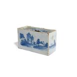 A delftware flower brick c.1750-60, painted with towers and other buildings to the long sides, the