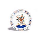 A Delft plate c.1720, of pancake form, brightly painted in polychrome enamels with two birds