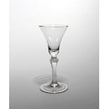 A balustroid wine glass c.1740, with a generous bell bowl raised on a plain stem with a beaded