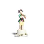 A Meissen figure of a young musician mid 18th century, modelled as a boy standing barefoot on top of