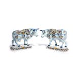 A pair of Delft models of cows 18th/19th century, each standing on a rectangular base with head