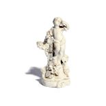 A Plymouth white-glazed figure of a putto c.1770, probably emblematic of Autumn, holding a bunch