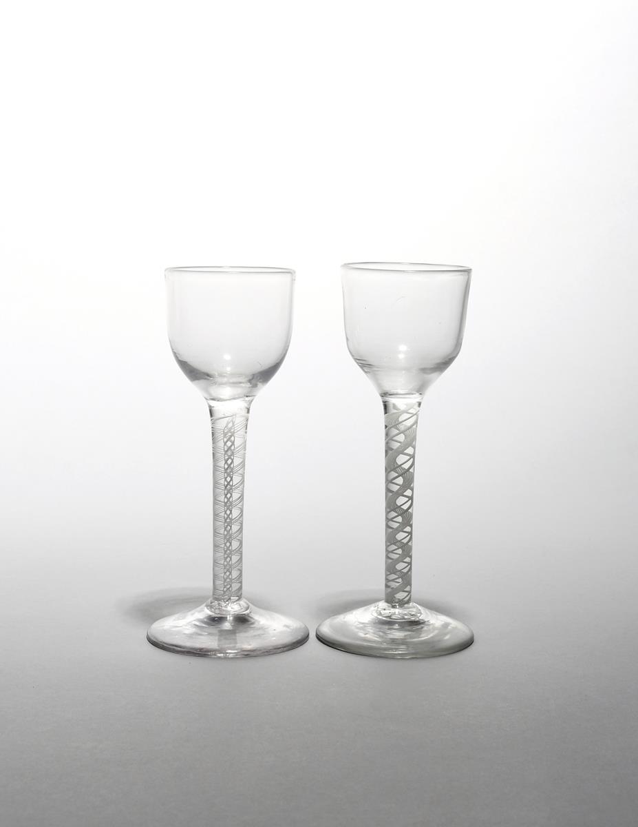 Two wine glasses c.1760-70, with small rounded funnel bowls raised on double series opaque twist