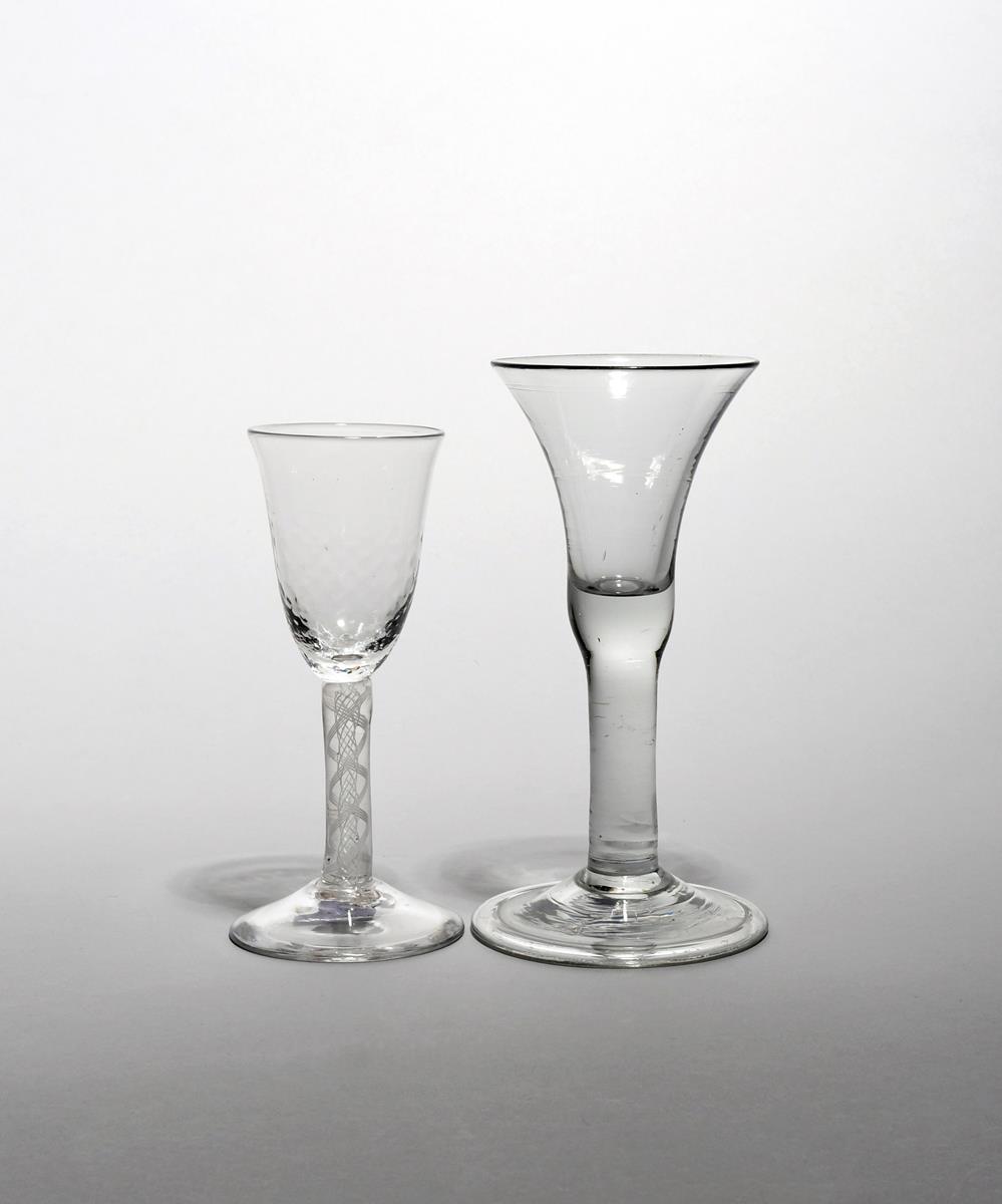 Two wine glasses c.1750-60, one with a bell bowl raised on a thick plain above a folded foot, the