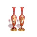 A tall pair of Bohemian glass vases late 19th century, each painted with the portrait of a young